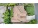 Aerial view of the home showing the terracotta roof, brick driveway, and manicured lawn and landscaping at 123 Tangelo Court, Maitland, FL 32751