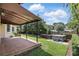 Landscaped backyard featuring a brick patio with awning and a hot tub for relaxation at 123 Tangelo Court, Maitland, FL 32751