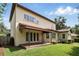 View of the back of the house showing the patio, awning, and manicured lawn with landscaping at 123 Tangelo Court, Maitland, FL 32751