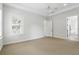 Large, bright bedroom with tray ceiling, carpet flooring, and adjacent bath at 123 Tangelo Court, Maitland, FL 32751