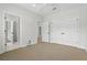 Carpeted bedroom with multiple doorways, a ceiling fan, and closet space at 123 Tangelo Court, Maitland, FL 32751