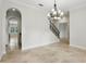 Formal dining room with stone floors, archway and modern chandelier at 123 Tangelo Court, Maitland, FL 32751