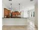Open kitchen with granite counters, tile backsplash, and pendant lighting above the bar at 123 Tangelo Court, Maitland, FL 32751