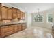 Beautiful kitchen with custom wood cabinetry, tiled backsplash, and travertine floors at 123 Tangelo Court, Maitland, FL 32751