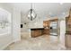 Kitchen with bar, stainless appliances, and stone flooring adjacent to breakfast nook with plantation shutters at 123 Tangelo Court, Maitland, FL 32751