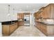 Well-equipped kitchen with stainless steel appliances, dark countertops and custom wood cabinetry at 123 Tangelo Court, Maitland, FL 32751