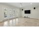 Bright living room featuring large French doors, neutral walls, and stone tile flooring at 123 Tangelo Court, Maitland, FL 32751