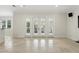 Bright living area with stone floors and natural light from a wall of four glass doors at 123 Tangelo Court, Maitland, FL 32751