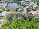 An aerial view shows the community, including ponds, pools, and well-maintained residences at 12618 Greco Dr, Orlando, FL 32824