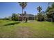 Spacious backyard with mature landscaping and an enclosed pool area, perfect for outdoor activities and relaxation at 12618 Greco Dr, Orlando, FL 32824