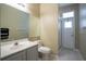 Bathroom with shower and door that leads to the exterior at 12618 Greco Dr, Orlando, FL 32824