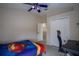 Bedroom featuring desk, chair, Superman bedding, and dual window shades at 12618 Greco Dr, Orlando, FL 32824