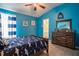 Blue bedroom features wood dresser, shark decor, and nautical-themed artwork at 12618 Greco Dr, Orlando, FL 32824