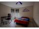 Bedroom with desk, chair, Superman bedding, and dual window shades for adjustable lighting at 12618 Greco Dr, Orlando, FL 32824