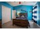 Bright bedroom with blue walls, wood bed frame, nautical decor, and ample closet space at 12618 Greco Dr, Orlando, FL 32824