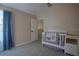 Cozy Bedroom featuring a white crib with fox-themed bedding and bright blue curtains at 12618 Greco Dr, Orlando, FL 32824
