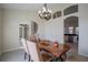 Formal dining room featuring a chandelier, open archways and wood-look flooring at 12618 Greco Dr, Orlando, FL 32824