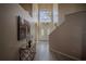 Bright foyer with a soaring ceiling, double doors, decorative glass, and light wood-look flooring at 12618 Greco Dr, Orlando, FL 32824