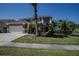 Well-maintained two-story home with three-car garage, mature landscaping, and a welcoming front facade at 12618 Greco Dr, Orlando, FL 32824