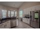 Modern kitchen with stainless steel appliances, granite countertops, and tile flooring at 12618 Greco Dr, Orlando, FL 32824