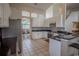 Kitchen boasts white cabinetry, granite counters, stainless appliances, and a view to the breakfast nook at 12618 Greco Dr, Orlando, FL 32824