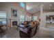 Open-concept living room has a fireplace and wood-look flooring and transitions into the kitchen and dining area at 12618 Greco Dr, Orlando, FL 32824