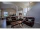 Open-concept living room flows into a dining area and kitchen, featuring wood-look floors at 12618 Greco Dr, Orlando, FL 32824