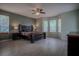 Spacious main bedroom with hard wood flooring, ceiling fan, and large windows at 12618 Greco Dr, Orlando, FL 32824