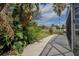 The backyard patio offers a tranquil view of the pond, enhanced by tropical landscaping and swaying palm trees at 12618 Greco Dr, Orlando, FL 32824