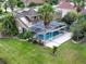 Aerial view of a private pool and backyard, enclosed with a screened enclosure for year-round enjoyment at 12618 Greco Dr, Orlando, FL 32824