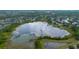 Aerial view of a lake surrounded by a residential area and abundant greenery at 14231 Sonco Ave, Windermere, FL 34786