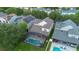Aerial view of the home showcasing a screened pool area, solar panels, and the surrounding neighborhood at 14231 Sonco Ave, Windermere, FL 34786