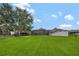 Expansive backyard featuring lush lawn and a screened-in lanai, perfect for outdoor relaxation and entertainment at 14231 Sonco Ave, Windermere, FL 34786