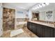 Bathroom features a tiled shower, soaking tub, a double vanity with granite countertops, and decorative wall accents at 14231 Sonco Ave, Windermere, FL 34786