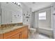 Bathroom with a granite countertop and a shower-tub combo at 14231 Sonco Ave, Windermere, FL 34786