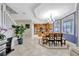 Open dining area with views to the kitchen, features hardwood flooring, decorative light fixture, and staircase nearby at 14231 Sonco Ave, Windermere, FL 34786