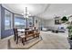 Spacious dining area with blue accent wall, tray ceiling, modern light fixture and views to outside at 14231 Sonco Ave, Windermere, FL 34786