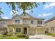 Charming two-story home featuring a welcoming front porch and a two-car garage at 14231 Sonco Ave, Windermere, FL 34786