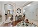Stylish foyer featuring an arched doorway, staircase, hardwood flooring and an ornate mirror and console table at 14231 Sonco Ave, Windermere, FL 34786
