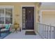 Inviting front porch with seating, lush landscaping, and a charming entrance at 14231 Sonco Ave, Windermere, FL 34786