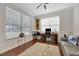 Bright home office features hardwood floors, a neutral rug, modern ceiling fan, and a gray couch at 14231 Sonco Ave, Windermere, FL 34786