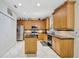 Well-equipped kitchen with an island, stainless steel appliances, modern lighting, and hardwood cabinets at 14231 Sonco Ave, Windermere, FL 34786