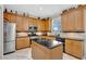 Charming kitchen equipped with stainless steel appliances, an island, and natural hardwood cabinets at 14231 Sonco Ave, Windermere, FL 34786