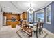 Kitchen featuring a blue accent wall, dining area, hardwood cabinetry, and stainless steel appliances at 14231 Sonco Ave, Windermere, FL 34786