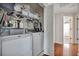Efficient laundry area with washer, dryer, and convenient storage shelves at 14231 Sonco Ave, Windermere, FL 34786