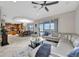 Open-concept living room with tile flooring, comfortable seating, and a view of the kitchen and outdoor area at 14231 Sonco Ave, Windermere, FL 34786