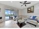 Bright living room featuring sliding glass doors to the lanai, tile flooring, and ceiling fan at 14231 Sonco Ave, Windermere, FL 34786