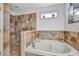 Spa-like bathroom with luxurious tub, tiled shower, and stylish fixtures at 14231 Sonco Ave, Windermere, FL 34786