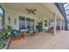 Relaxing covered outdoor patio with comfortable seating, ceiling fan and a serene backyard at 14231 Sonco Ave, Windermere, FL 34786