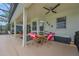 Spacious covered patio with a ceiling fan and outdoor seating provides a perfect spot for relaxation and gatherings at 14231 Sonco Ave, Windermere, FL 34786